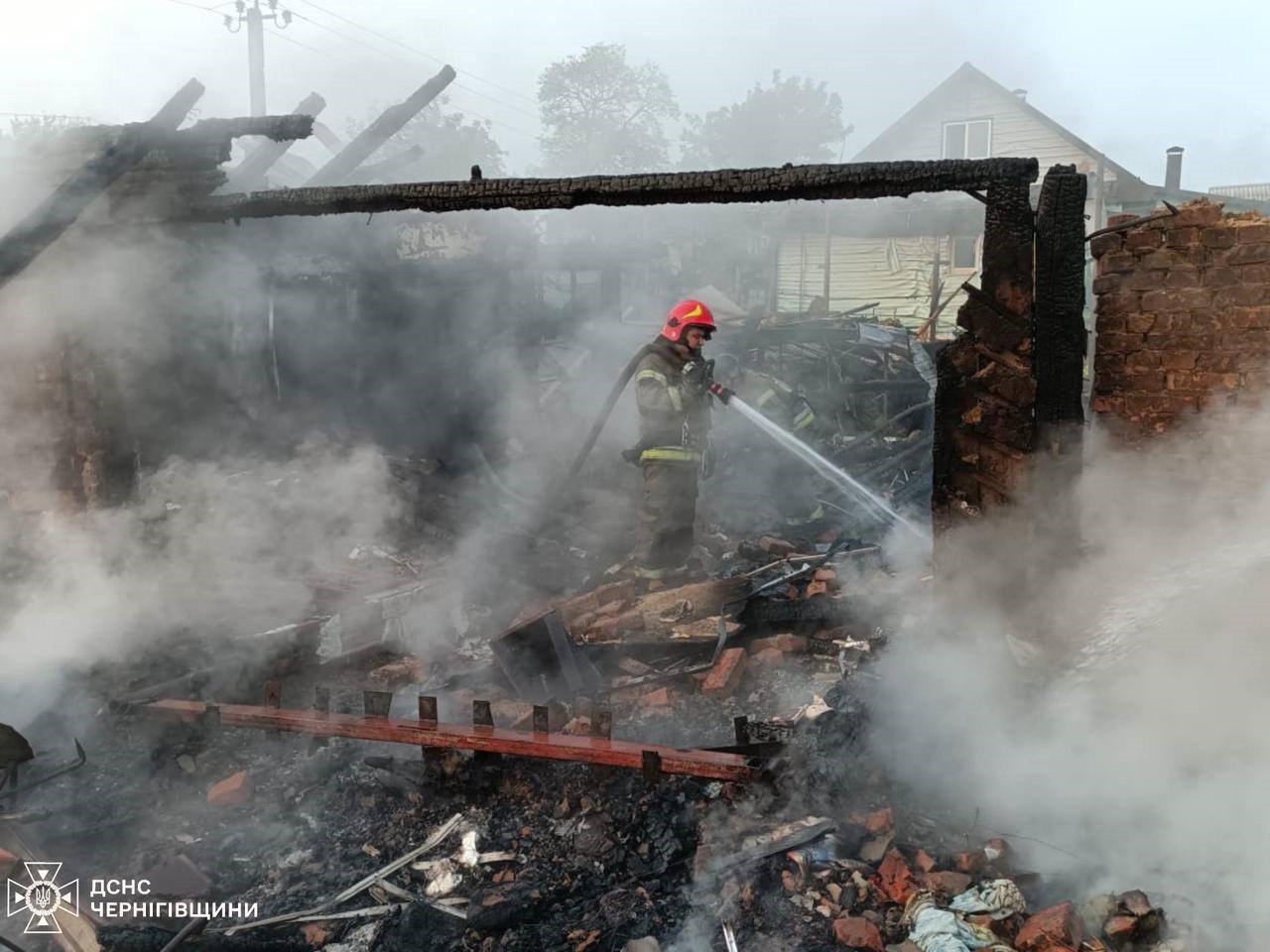 A firefighter works at the site of a Russian drone strike in Pryluky, central Ukraine, June 5, 2025. (IHA Photo)