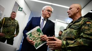 German President Frank-Walter Steinmeier listens to Sergeant Major, medical officer and artist Andreas Steinkat who explains his art pieces hanging in the Veterans Office, in Berlin, Germany, June 3, 2025. (Reuters Photo)