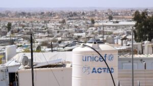 Corrugated iron huts and a water tank labeled UNICEF stand in the Jordanian refugee camp Saatari, bordering Syria, Saatari, Jordan,27 March 2025. (Getty Images Photo)
