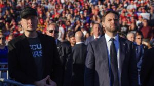Elon Musk (L) and Republican vice presidential nominee Sen. JD Vance, R-Ohio, listen as Republican presidential nominee former President Donald Trump speaks at a campaign rally, Butler, U.S., Oct. 5, 2024. (AP Photo)