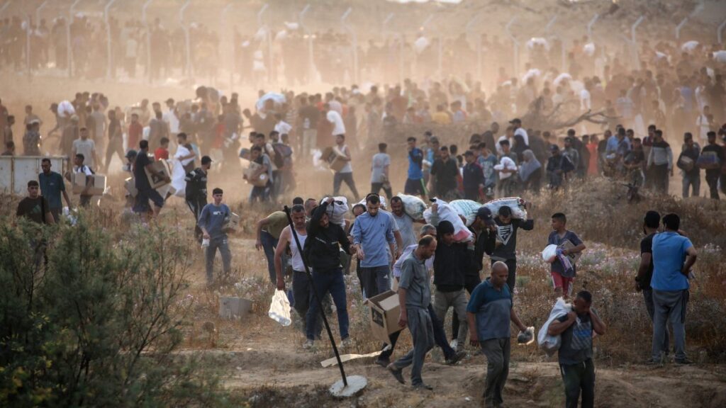 People carry relief supplies from the Gaza Humanitarian Foundation (GHF), a private U.S.-backed aid group that has bypassed the longstanding U.N.-led system in the territory, central Gaza Strip, Palestine, June 8, 2025. (AFP Photo)
