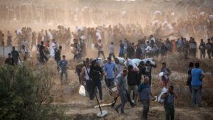 People carry relief supplies from the Gaza Humanitarian Foundation (GHF), a private U.S.-backed aid group that has bypassed the longstanding U.N.-led system in the territory, central Gaza Strip, Palestine, June 8, 2025. (AFP Photo)