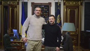 Ukrainian President Volodymyr Zelenskyy (R) and Ukraine's boxer Oleksandr Usyk pose for a photo in the Presidential Office, Kyiv, Ukraine, Dec. 31, 2024. (AP Photo)