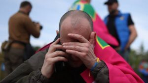 This handout photograph taken and released by the Ukrainian Presidential Press Service shows a Ukrainian prisoner of war (POW) speaking on a mobile phone following an exchange of prisoners at an undisclosed location in Ukraine, June 14, 2025. (AFP Photo)