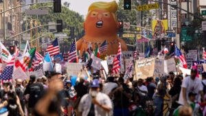 A balloon of U.S. President Donald Trump in a diaper is seen among people taking part in a "No Kings" protest in Los Angeles, California, June 14, 2025. (AFP Photo)