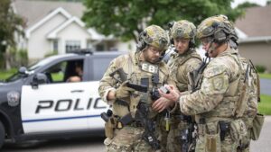 Armed FBI agents have a meeting to strategize as they search for an active shooter in Brooklyn Park, Minnesota, U.S., June 14, 2025. (AP Photo)