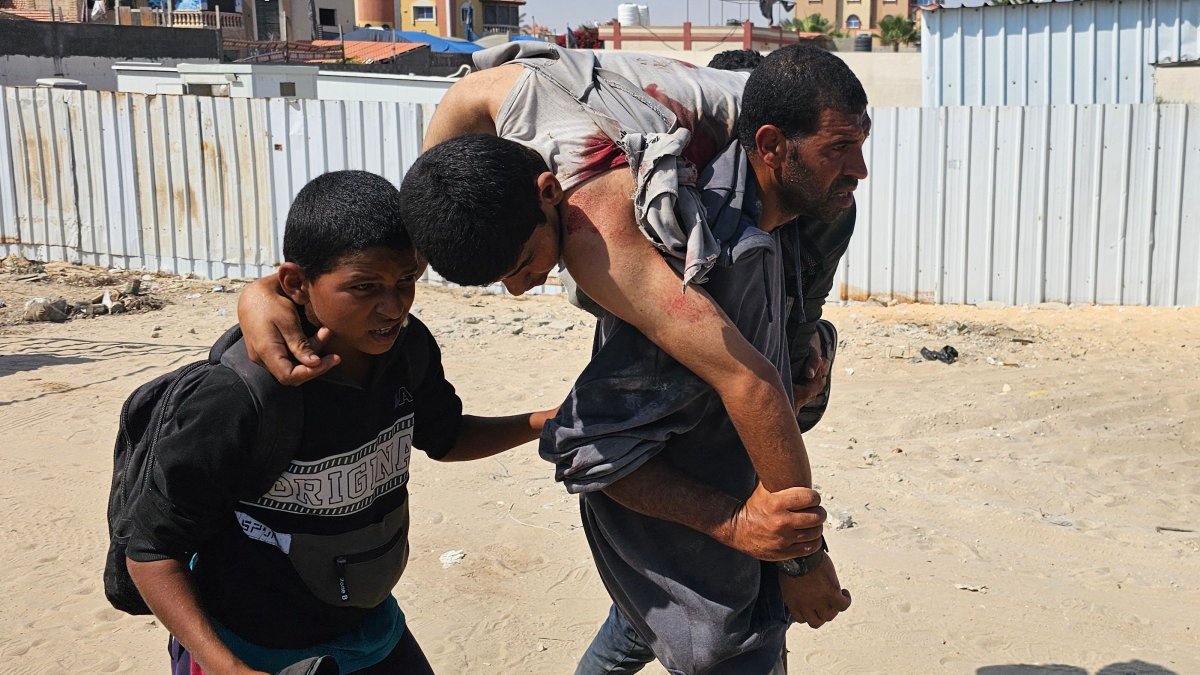 Palestinians carry a wounded man, injured as he was queuing for aid in Rafah, southern Gaza Strip, Palestine, June 16, 2025. (AFP Photo)