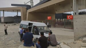 People wait after crossing from Iran into Türkiye at Gürbulak-Bazargan border post, Ağrı, eastern Türkiye, Jun. 16, 2025. (AP Photo)