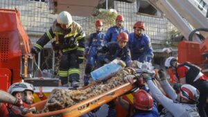 Ukrainian rescuers evacuate an injured elderly woman from the site of an airstrike on a nine-story residential building in Kyiv, Ukraine, June 17, 2025. (EPA Photo)