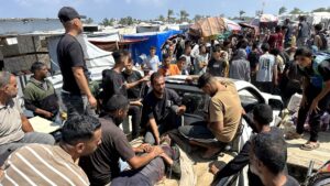 Palestinians evacuate a wounded man amid long queues for receiving humanitarian aid in the southern Gaza city of Rafah, June 15, 2025. (AFP Photo)