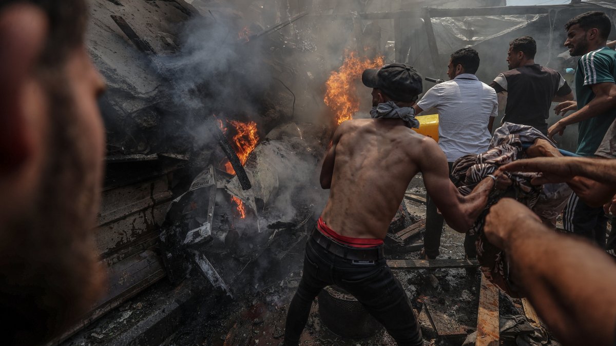 Palestinians try to put out a fire caused by Israeli strikes in the Shati refugee camp, western Gaza, Palestine, June 19, 2025. (AA Photo)