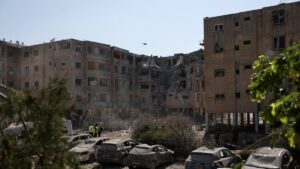 Emergency personnel walk near damaged vehicles at an impact site following a missile strike from Iran on Israel, in Holon, Israel June 19, 2025. (Reuters Photo)