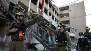 Israeli first responders work at the scene of a reported Iranian strike in Haifa on June 20, 2025, amid the ongoing fire exchange between Israel and Iran. (AFP Photo)
