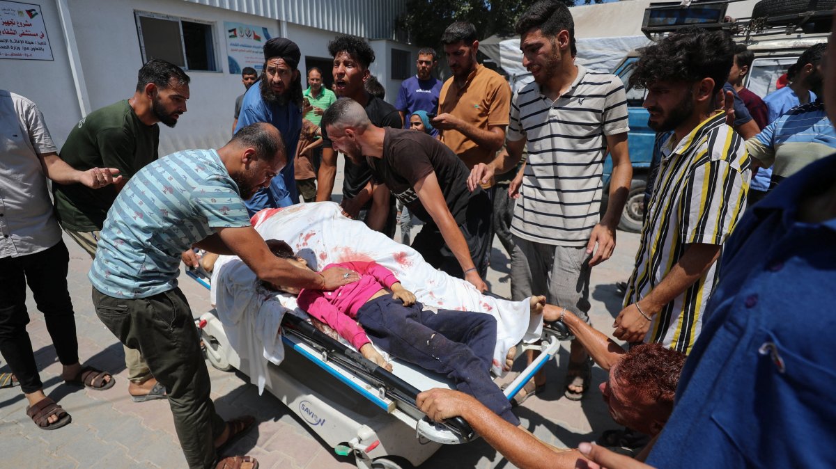 Mourners react around bodies, including a child, after Palestinians were killed by an Israeli strike on a tent encampment sheltering displaced people, at Al-Shifa Hospital, in Gaza City, June 19, 2025. (Reuters Photo)