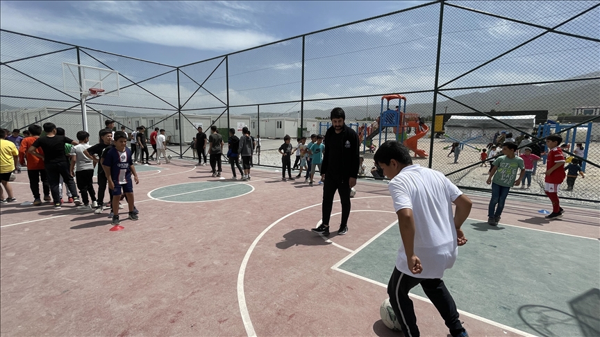 Quake survivor football coaches provide training to children in container city