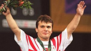 This file photo taken on July 22, 1996 shows Naim Suleymanoglu of Turkey raising his arms at the medal ceremony where he was awarded the gold in the 64kg division Olympic weightlifting. (Photo AFP)