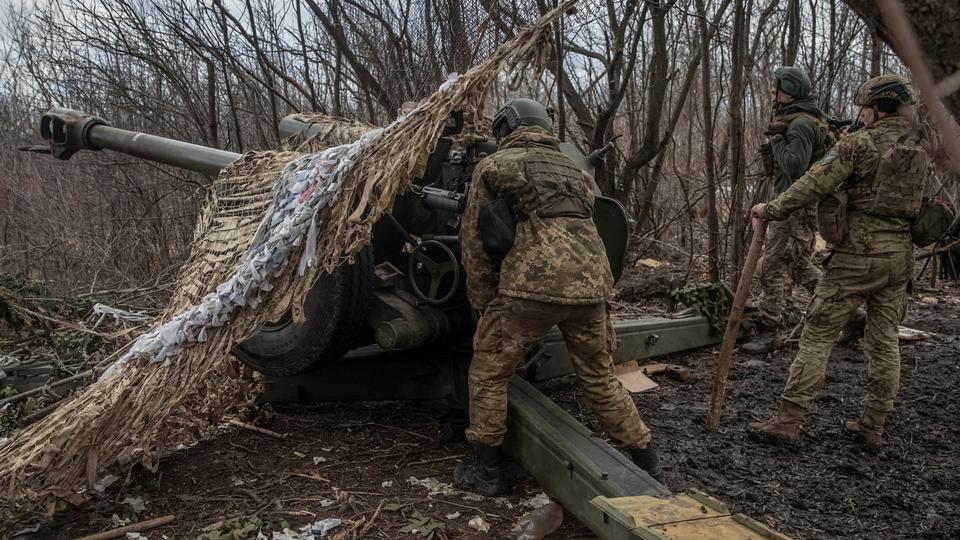 Ukrainian service members prepare to shoot from a howitzer at a front line, as Russia's attack on Ukraine continues in the Donetsk region on Thursday.