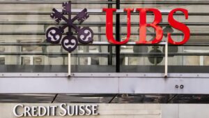 Logos of the Swiss banks Credit Suisse and UBS are seen on two buildings in Zurich, Switzerland, Saturday, March 18, 2023.