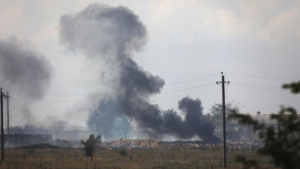 FILE – Smoke rises over the site of explosion at an ammunition storage of Russian army near the village of Mayskoye, Crimea, on August 16, 2022.