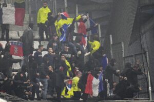 Lyon fans try to break the net on the stands prior to the French Ligue 1 match against Marseille, Velodrome Stadium, Marseille, France, Oct. 29, 2023. (AP Photo)